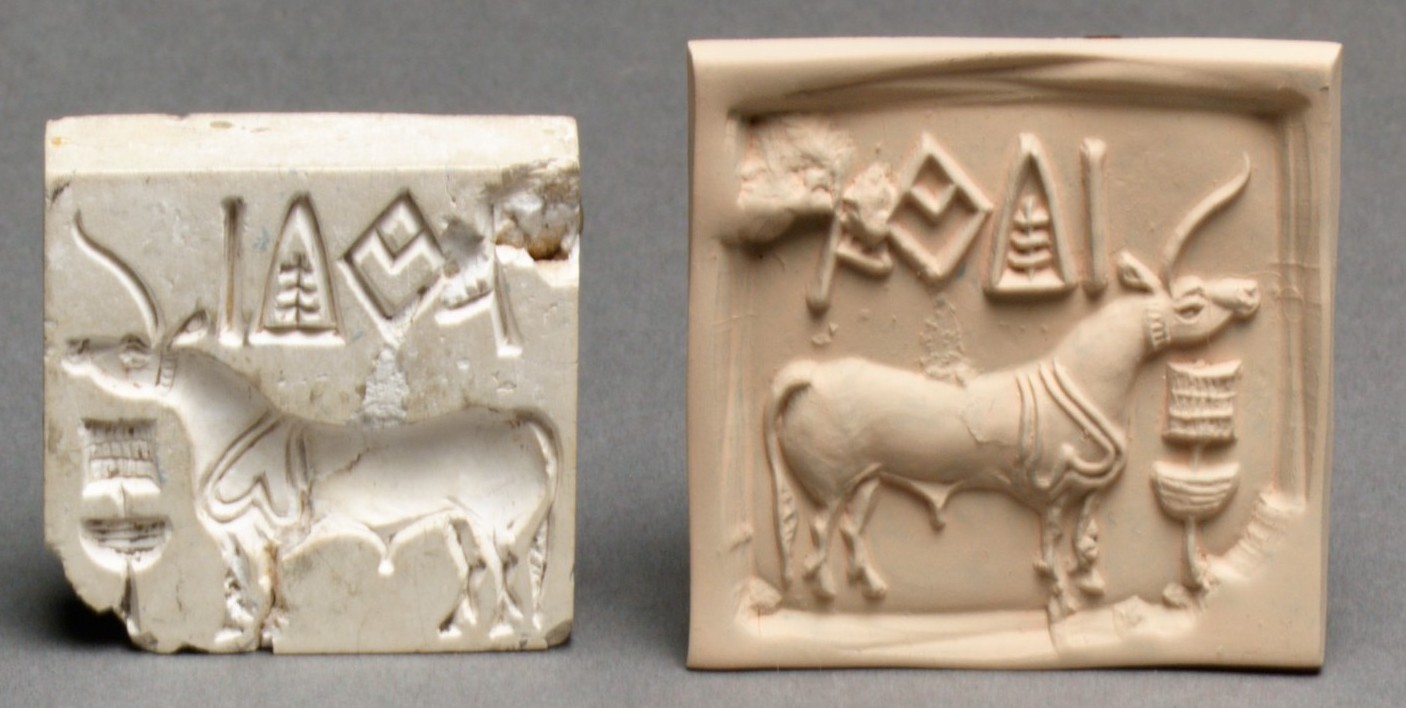 Two tablets containing drawings of animals and symbols